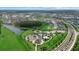 An aerial view showcases the community, ponds, playground, and pool at 33219 Kateland Dr, Wesley Chapel, FL 33545