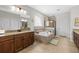 The bathroom has a soaking tub and glass-enclosed shower, designed for comfort and style at 33219 Kateland Dr, Wesley Chapel, FL 33545
