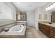 Bright bathroom featuring a soaking tub, walk-in shower, granite countertop vanity, and neutral tile at 33219 Kateland Dr, Wesley Chapel, FL 33545