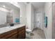 Bathroom featuring a toilet, sink, shower, and a glass door leading to the backyard at 33219 Kateland Dr, Wesley Chapel, FL 33545