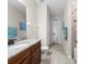 Bathroom featuring a toilet, sink, shower, and a glass door leading to the backyard at 33219 Kateland Dr, Wesley Chapel, FL 33545