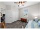 Bedroom featuring a ceiling fan, a window, a closet, a door, and a daybed with blue bedding at 33219 Kateland Dr, Wesley Chapel, FL 33545