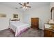 Bedroom showcasing a ceiling fan, carpet, closet, and dresser at 33219 Kateland Dr, Wesley Chapel, FL 33545