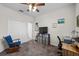 Bedroom with ceiling fan, closet, blue rocking chair, desk, and carpet at 33219 Kateland Dr, Wesley Chapel, FL 33545