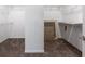 Walk-in closet with wall mounted shelving and tan carpet at 33219 Kateland Dr, Wesley Chapel, FL 33545