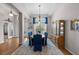 The dining room is well-lit and features hardwood floors, and decoratively-covered chairs at 33219 Kateland Dr, Wesley Chapel, FL 33545