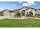 Beautiful single-story home with a brick paver driveway and lush front lawn and landscaping at 33219 Kateland Dr, Wesley Chapel, FL 33545