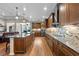 Open kitchen featuring a large island, stainless steel appliances, and elegant stone backsplash at 33219 Kateland Dr, Wesley Chapel, FL 33545