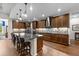 Gourmet kitchen boasts a large island with seating, stainless steel appliances, and custom cabinetry at 33219 Kateland Dr, Wesley Chapel, FL 33545