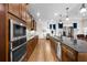 Gourmet kitchen with stainless appliances, granite countertops, and wooden cabinets is a chef's dream at 33219 Kateland Dr, Wesley Chapel, FL 33545