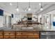 The kitchen island overlooks the living area with its stone fireplace and wall decor at 33219 Kateland Dr, Wesley Chapel, FL 33545