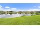 Scenic view of a calm lake surrounded by well-maintained homes and lush greenery, enhancing community appeal at 33219 Kateland Dr, Wesley Chapel, FL 33545