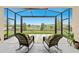 Relax on the screened lanai overlooking the serene lake view, perfect for outdoor living and entertaining at 33219 Kateland Dr, Wesley Chapel, FL 33545
