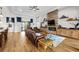 Spacious living area with hardwood floors, a stone fireplace, and sliding glass doors to the lanai at 33219 Kateland Dr, Wesley Chapel, FL 33545
