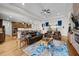 Open concept living room featuring hardwood floors, tray ceilings, and stone fireplace at 33219 Kateland Dr, Wesley Chapel, FL 33545
