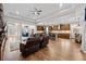 Large, open-concept living space with hardwood floors connecting to the kitchen and dining areas at 33219 Kateland Dr, Wesley Chapel, FL 33545