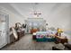 A large main bedroom offers a tray ceiling, ceiling fan, carpet, and ample natural light at 33219 Kateland Dr, Wesley Chapel, FL 33545