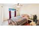 Comfortable bedroom with window, lamps, and ceiling fan at 3411 Landover Blvd, Spring Hill, FL 34609