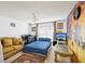 Bright bedroom with crib, sofa, and tropical sunset wall decor at 3411 Landover Blvd, Spring Hill, FL 34609