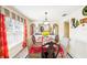 Elegant dining room with decorative curtains, large mirror, and dining set with upholstered chairs at 3411 Landover Blvd, Spring Hill, FL 34609