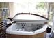 Relax in this inviting hot tub featuring multiple jets and a convenient cover for maintenance and privacy at 3411 Landover Blvd, Spring Hill, FL 34609