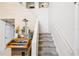 Carpeted stairway with white railing and decorative accents on landing at 3411 Landover Blvd, Spring Hill, FL 34609
