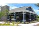 Community building with stone accents, outdoor seating, and manicured landscaping at 4444 Aqua Mirage St, Sarasota, FL 34238