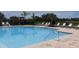 Community pool with plenty of chairs, lush landscaping, and pergolas enhance outdoor living at 4444 Aqua Mirage St, Sarasota, FL 34238