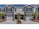 Charming townhomes with two-car garages, stone accents and manicured landscaping create curb appeal at 4444 Aqua Mirage St, Sarasota, FL 34238