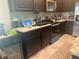 Kitchen featuring modern appliances, granite countertops, dark cabinetry, and eat-in space at 4444 Aqua Mirage St, Sarasota, FL 34238
