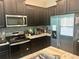 Well-equipped kitchen featuring stainless steel appliances, granite countertops, and dark cabinetry at 4444 Aqua Mirage St, Sarasota, FL 34238