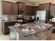 Modern kitchen with granite counters, stainless appliances, an island, and seating at 4444 Aqua Mirage St, Sarasota, FL 34238