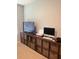 Living room featuring built-in shelving, flat screen TV, and modern desk setup at 4444 Aqua Mirage St, Sarasota, FL 34238