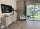 Cozy living room with stylish decor, tile floors, and sliding glass doors to an outdoor patio at 4444 Aqua Mirage St, Sarasota, FL 34238