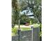 Landscaped street view near cross walk, red car crossing the street at 4444 Aqua Mirage St, Sarasota, FL 34238