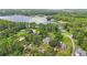 Breathtaking aerial view of a lakefront property surrounded by lush greenery and mature trees at 4783 School Rd, Land O Lakes, FL 34638