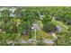 Aerial view of a home with a long front yard and surrounding trees at 4783 School Rd, Land O Lakes, FL 34638