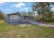 Charming single-story home with a serene backyard, featuring a screened-in porch at 4783 School Rd, Land O Lakes, FL 34638