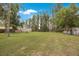 Beautiful lush backyard with plenty of room and greenery surrounded by mature trees at 4783 School Rd, Land O Lakes, FL 34638