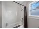 Bathroom featuring tile floors and bathtub with shower at 4783 School Rd, Land O Lakes, FL 34638