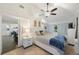 Bright bedroom featuring a ceiling fan, neutral walls, and access to the rest of the house at 4783 School Rd, Land O Lakes, FL 34638