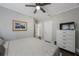 Bedroom features a ceiling fan, neutral walls, dresser, and hardwood floors at 4783 School Rd, Land O Lakes, FL 34638