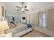 Bright bedroom featuring a ceiling fan, neutral walls, and windows providing ample natural light at 4783 School Rd, Land O Lakes, FL 34638