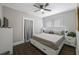 Bedroom featuring hardwood floors, a ceiling fan, natural light from the windows and a dresser at 4783 School Rd, Land O Lakes, FL 34638