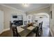 Formal dining room has an open layout, dark wood floors, and table for eight guests at 4783 School Rd, Land O Lakes, FL 34638