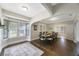 Bright dining room with bay window, hardwood floors, and table for eight guests at 4783 School Rd, Land O Lakes, FL 34638