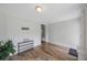 Neat entryway featuring wood-look floors, a 'welcome' sign, and neutral decor creating a clean, inviting space at 4783 School Rd, Land O Lakes, FL 34638
