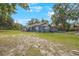 Exterior view of charming home, enhanced by mature trees, set on a well-maintained lawn at 4783 School Rd, Land O Lakes, FL 34638