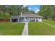 Charming single-story home with well-maintained lawn, covered parking, and classic architectural details at 4783 School Rd, Land O Lakes, FL 34638