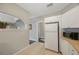 Galley kitchen features neutral decor, white appliances and view to dining area at 4783 School Rd, Land O Lakes, FL 34638